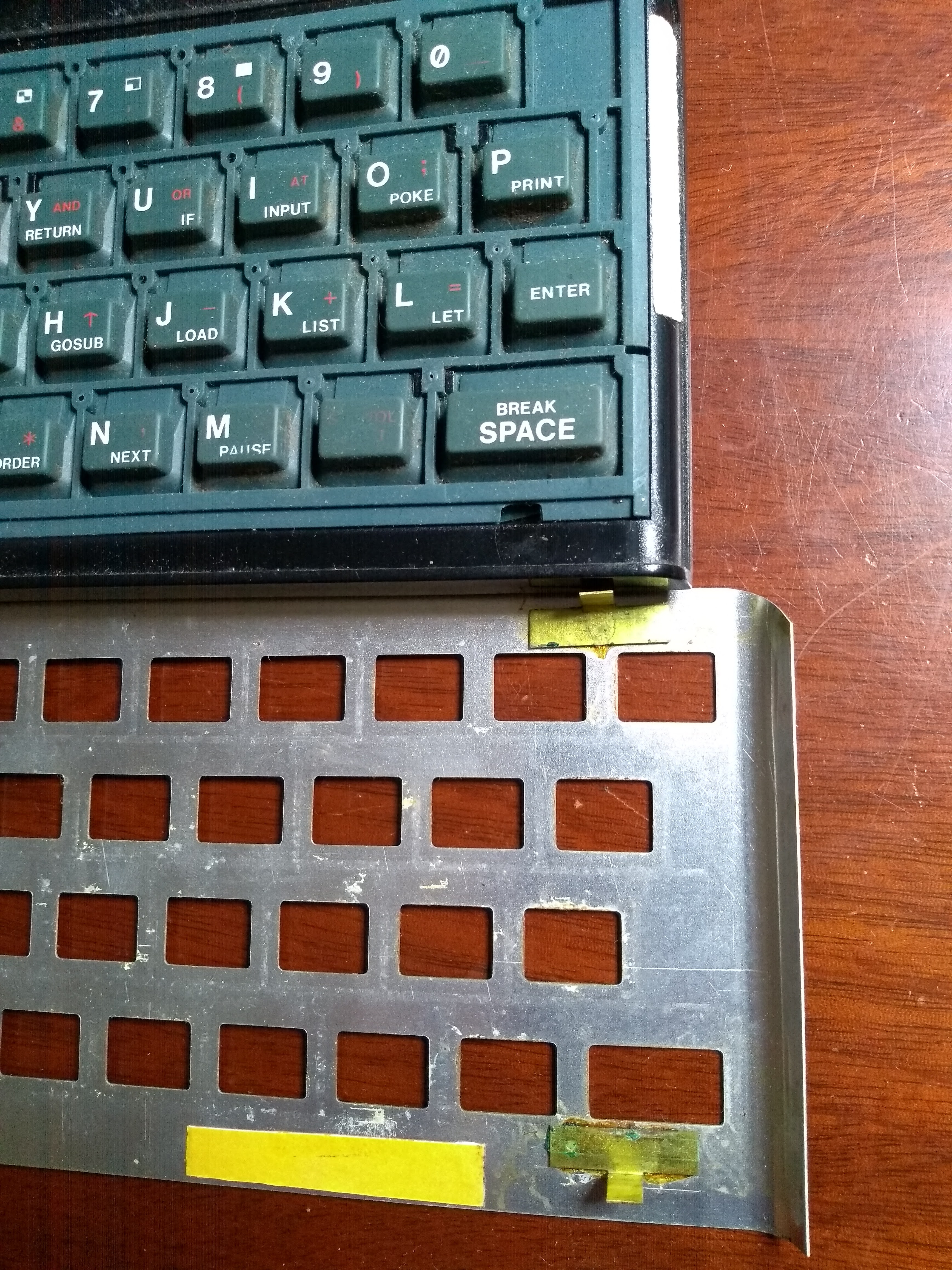 half of a ZX Spectrum with the metal keyboard cover
removed; a strip of yellow is the crucial carpet tape