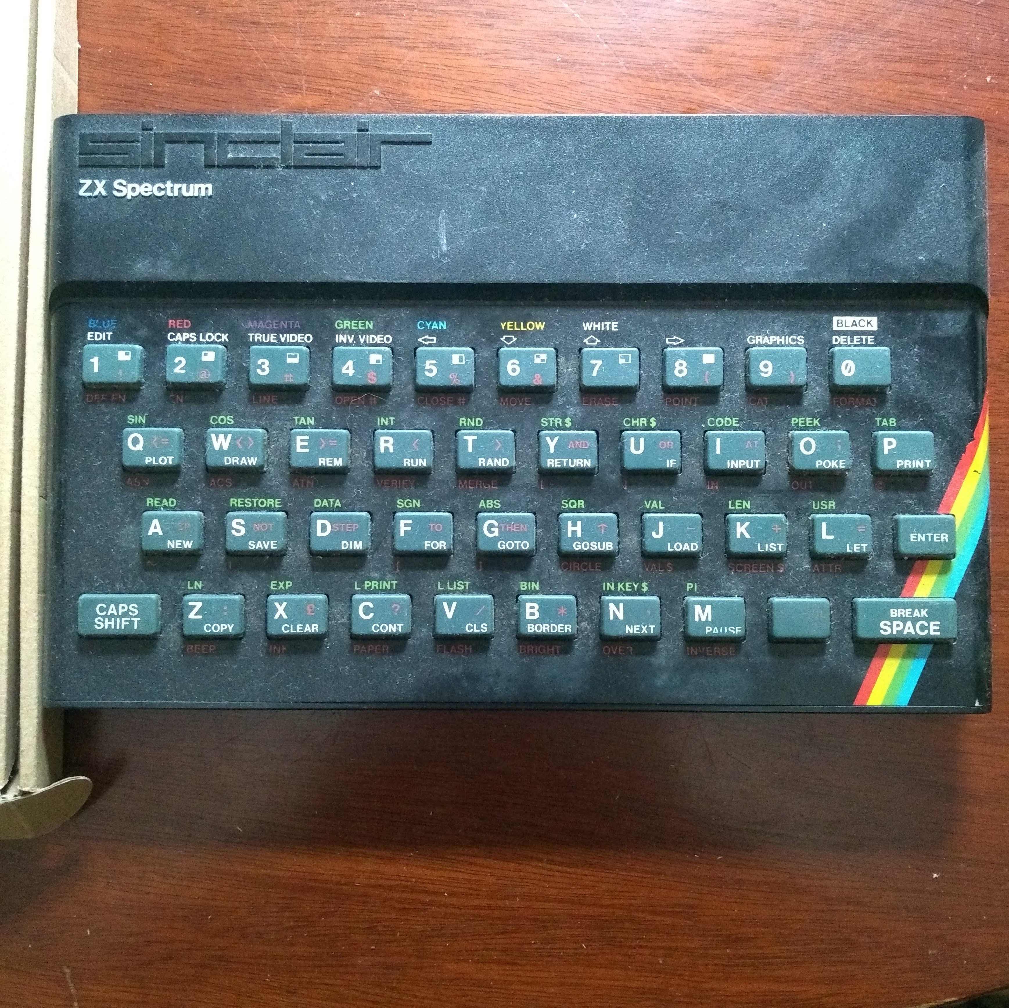 ZX Spectrum computer; small, mostly black with a rainbow stripe, with 40 squidgy grey keys